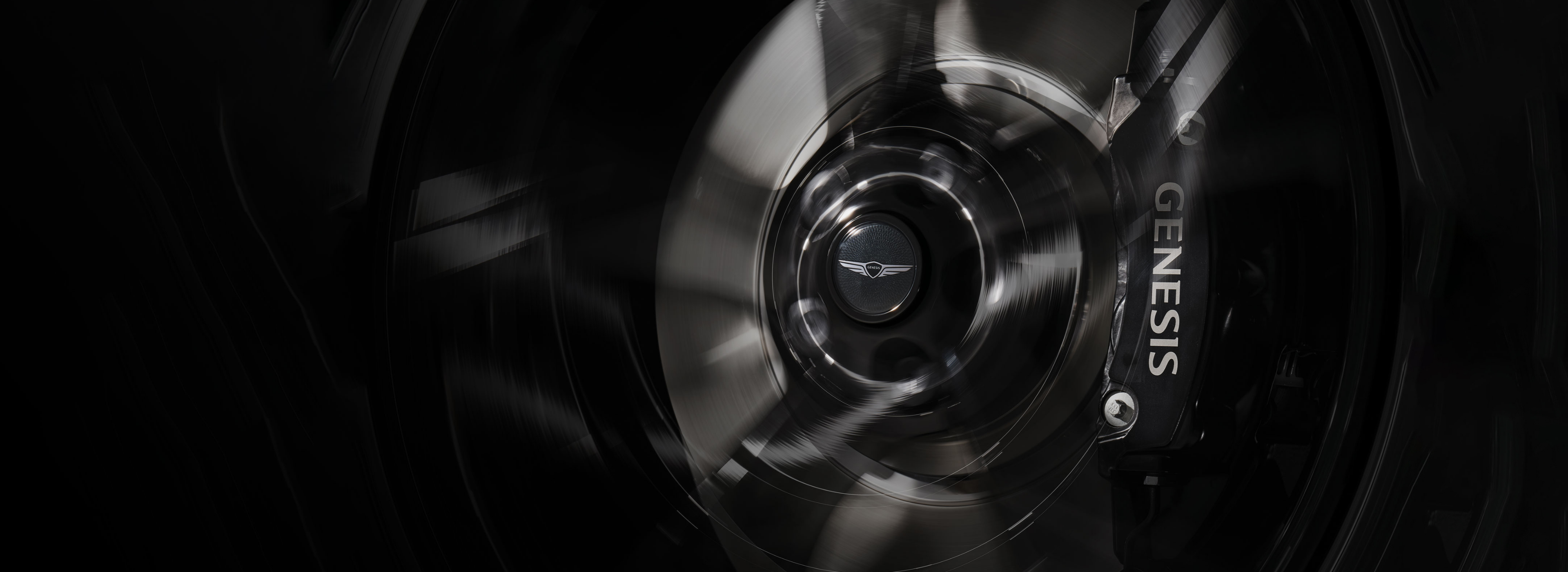 Genesis wheel and brake detail highlighting complimentary maintenance.