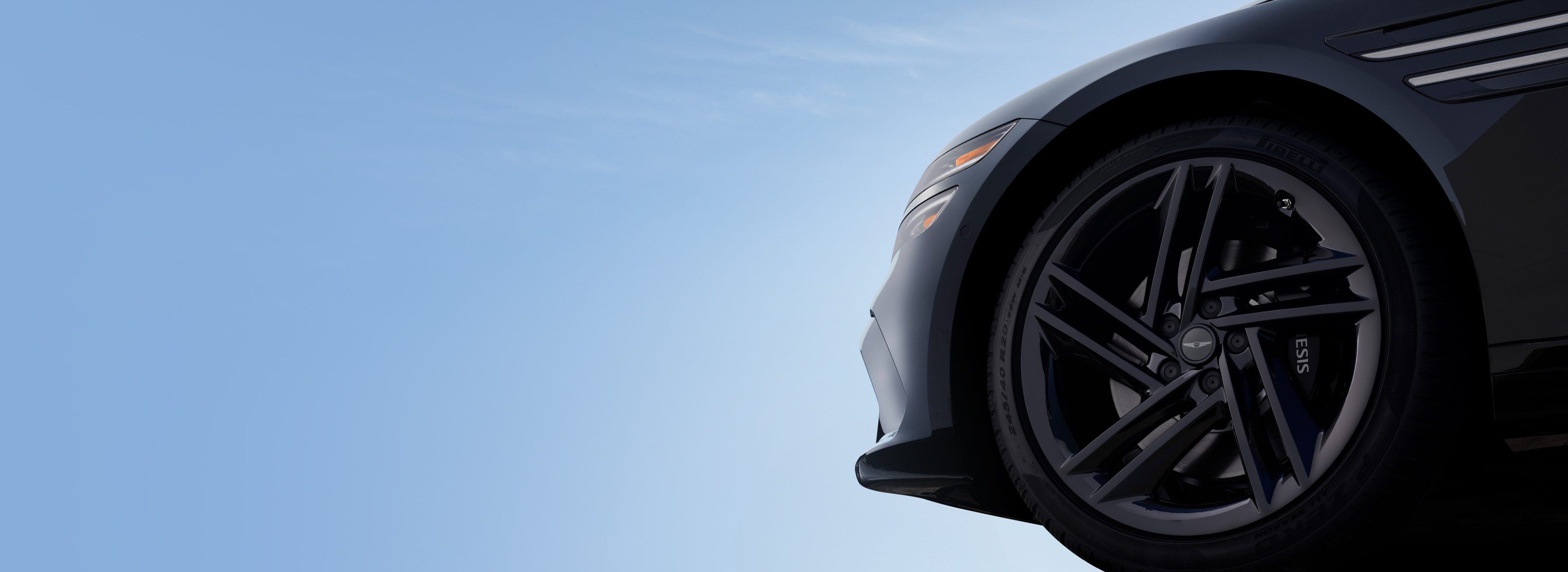 Genesis vehicle wheel with Genesis Tire Event promotion.