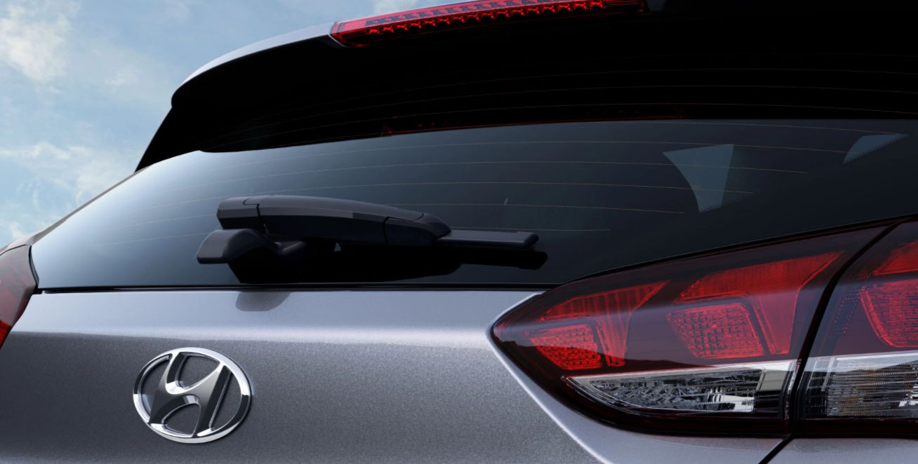Close-up of the rear of a silver Hyundai vehicle, showcasing the rear windshield wiper and taillights, with the Hyundai logo visible.