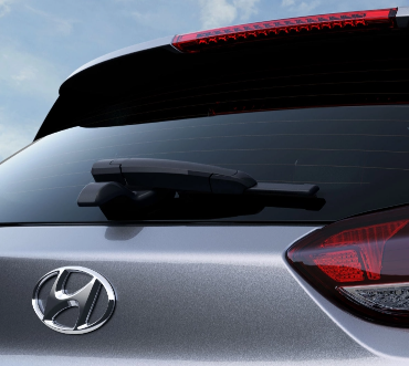 Close-up of the rear of a silver Hyundai vehicle, showcasing the rear windshield wiper and taillights, with the Hyundai logo visible.