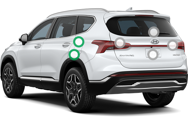 Rear 3/4 view of a white Hyundai Santa Fe.