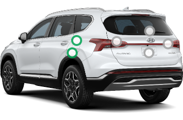 Rear 3/4 view of a white Hyundai Santa Fe.