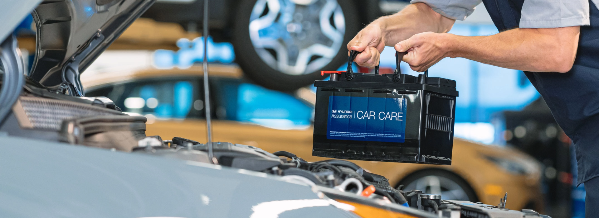 Technician installing a car battery.