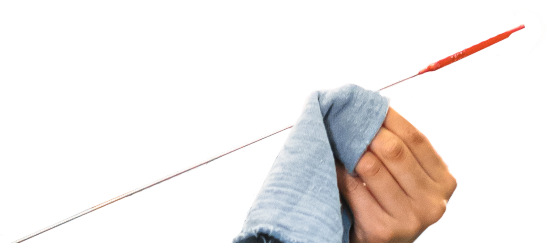 Person holding an oil dipstick with a red tip, wiping it with a blue cloth.