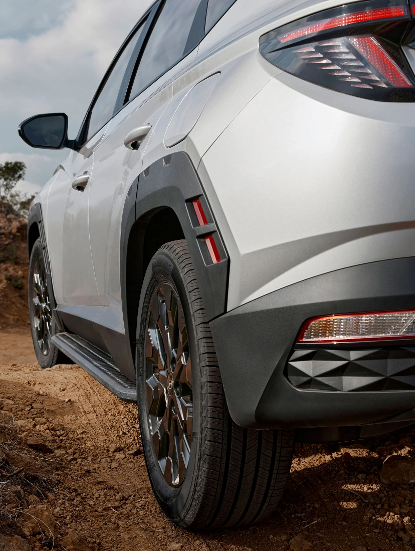 Hyundai SUV driving on rugged terrain with focus on rear tire