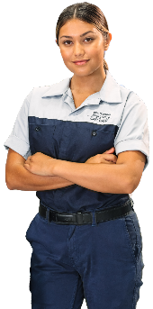 Smiling Hyundai female technician in uniform, standing confidently with arms crossed.