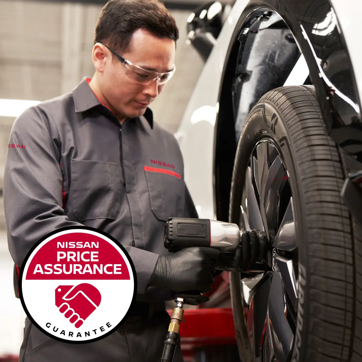 Nissan Price Assurance logo with Nissan-trained technician installing tire on car